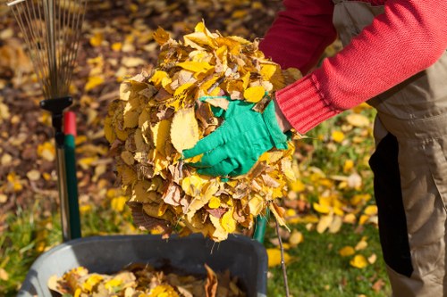 Garden clearance workers arranging compostable green waste in Crouch End